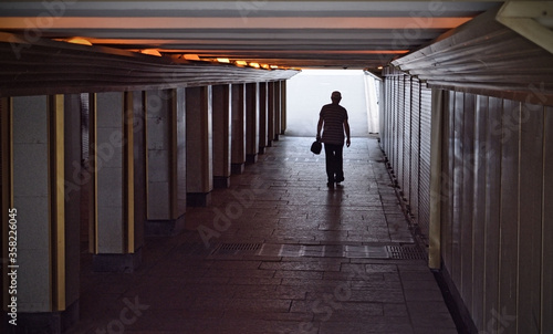 A man goes through an underpass.