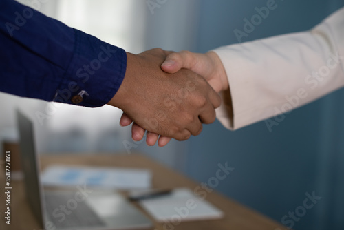 businessman and businesswoman shake hand after complete success project with teamwork. Business partnership meeting concept