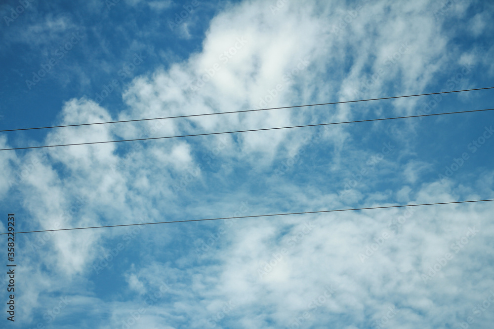 Fototapeta premium After rain beautiful gorgeous blue sky with electric cable . clouds in the sky