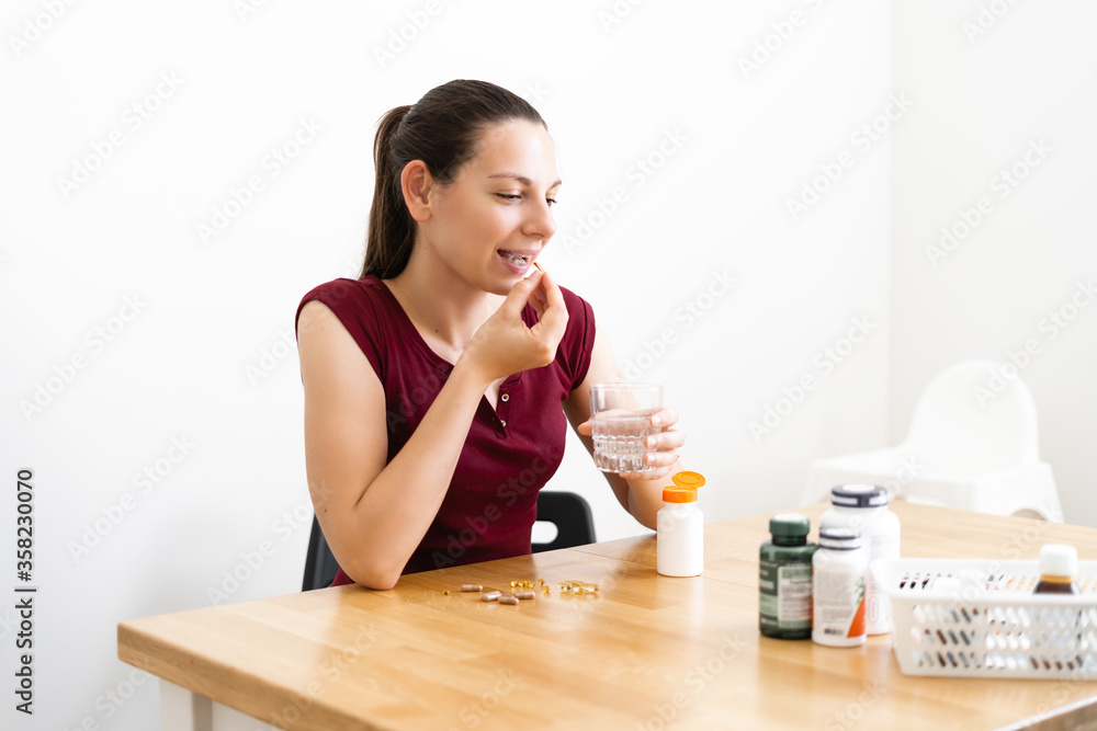 Caucasian woman drinks a lot of pills. Preventive medicine. Food supplements Caucasian woman drinks a lot of pills. Preventive medicine. Food supplements