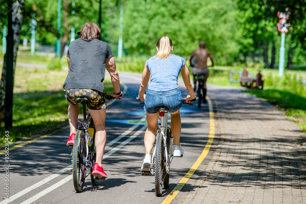 Cyclists ride on the bike path in the city Park
