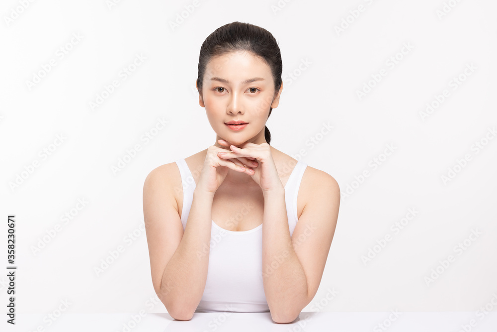 Beautiful Asian young woman holding hands smile with clean fresh skin Beautiful Asian young woman holding hands smile with clean fresh skin