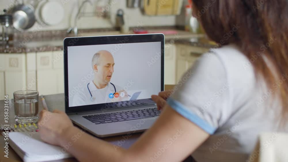 Patient and doctor during video call and online consultation. General practitioner consulting woman, discussing diagnosis and treatment during video conference laptop computer. Telemedicine concept Patient and doctor during video call and online consultation. General practitioner consulting woman, discussing diagnosis and treatment during video conference laptop computer. Telemedicine concept