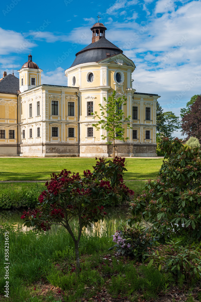 Kravare castle wirth Kaple sv. Michala chapel and flowering rhododendron in Czech republic