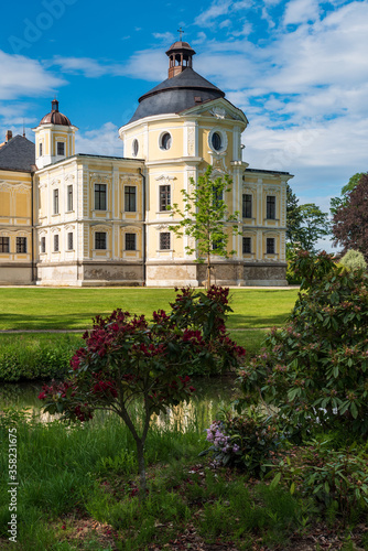 Kravare castle wirth Kaple sv. Michala chapel and flowering rhododendron in Czech republic