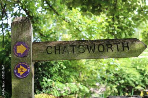 A beautiful direction sign to Chatsworth, Bakewell, Derbyshire, England taken on the summer with a countryside background 