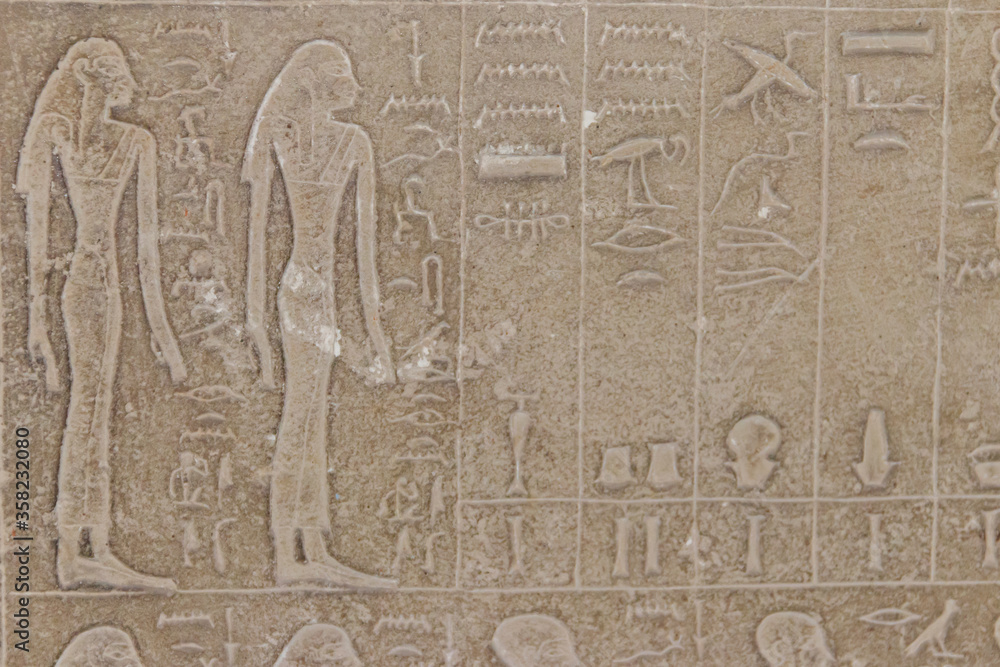 Ancient egyptian paintings and hieroglyphs carved on the stone wall Ancient egyptian paintings and hieroglyphs carved on the stone wall