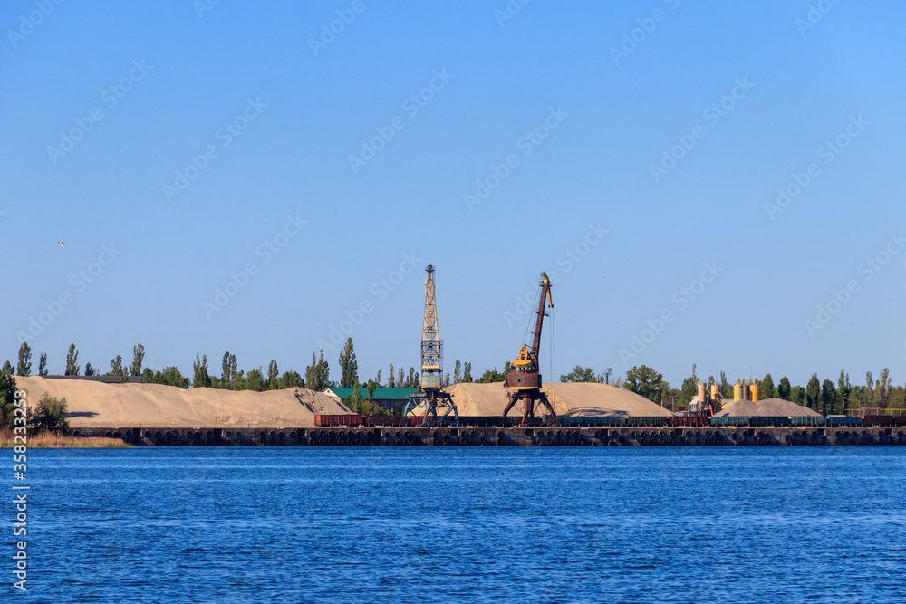 Hoisting cranes at cargo port on the Dnieper river in Kremenchug, Ukraine