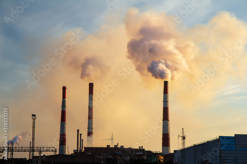 Pollution of the environment by the plant. Pipes with smoke, carbon dioxide emissions into the atmosphere. Industrial summer landscape with factory. Metallurgy and chemical business
