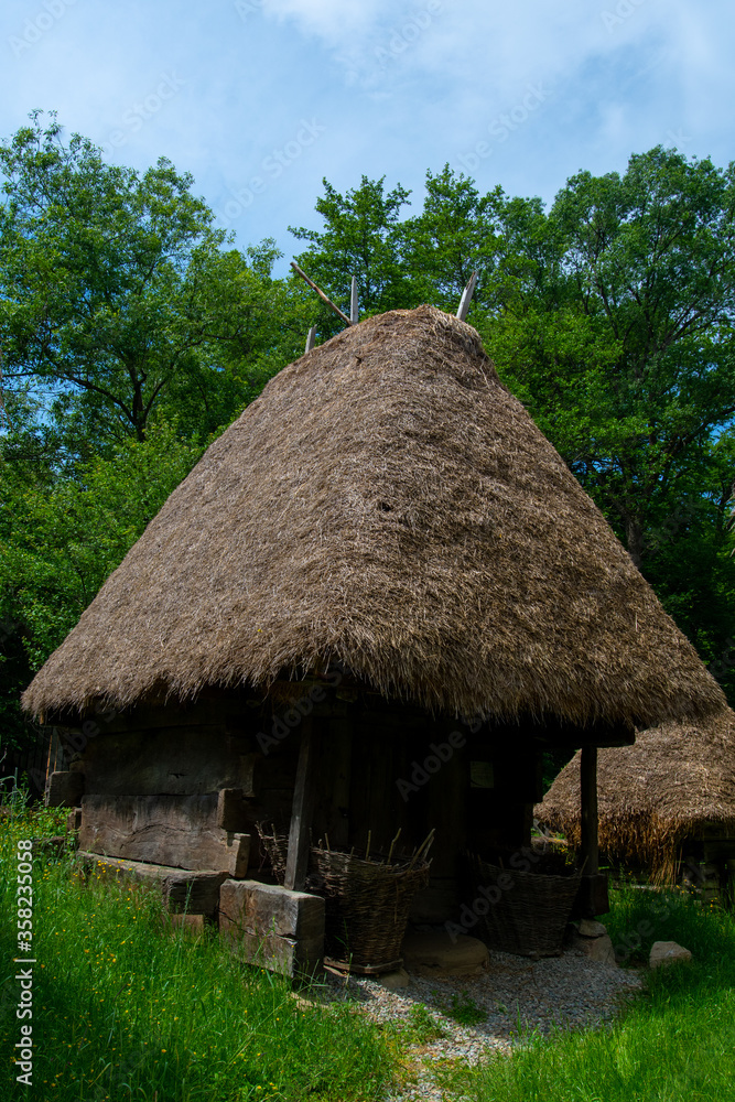traditional brick and clay house with thatched and wooden roof