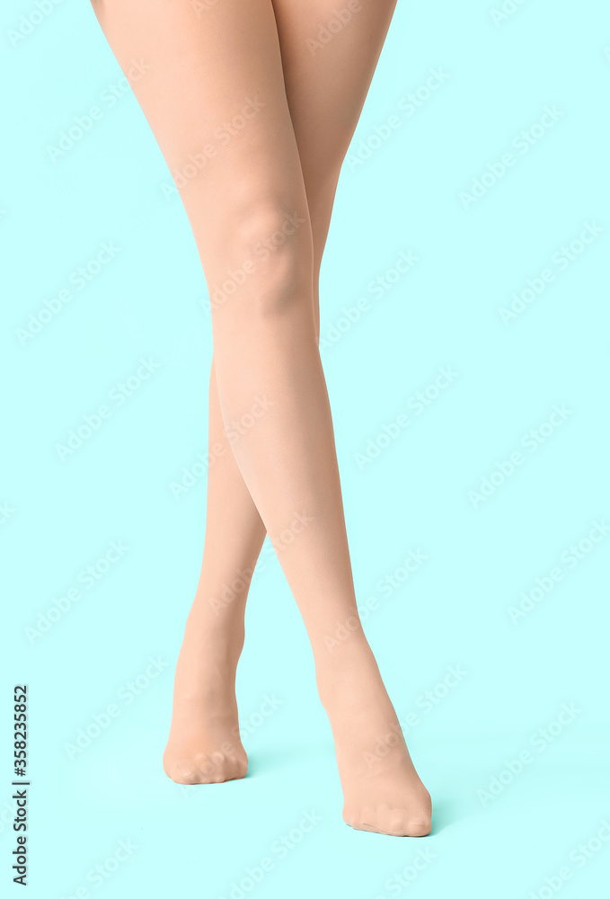 Beautiful young woman in tights on color background Beautiful young woman in tights on color background