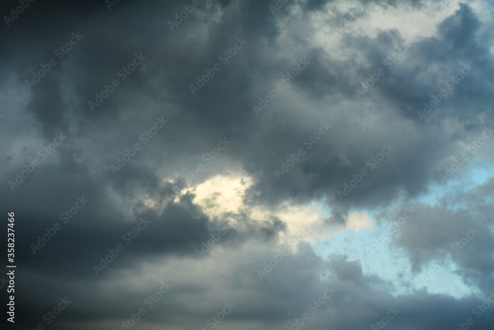 Picturesque clouds in the sky. Window view of an airplane on a sunny gloomy day. Stock photo background