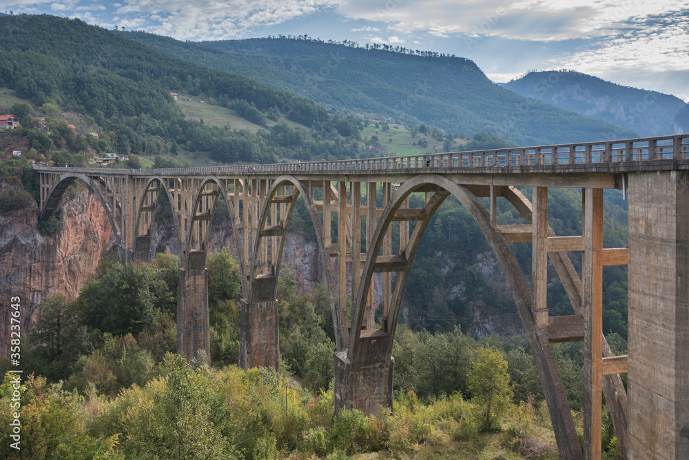 Djurdevica Tara concrete arch bridge over the Tara River, northern Montenegro. Amazing automobile bridge in Europe. Landscape, travel concept Djurdevica Tara concrete arch bridge over the Tara River, northern Montenegro. Amazing automobile bridge in Europe. Landscape, travel concept