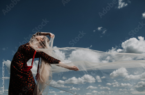 Young woman on a background of blue sky