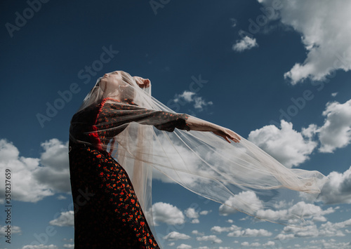 Young woman on a background of blue sky