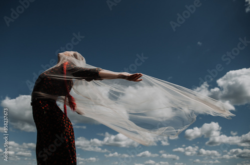 Young woman on a background of blue sky