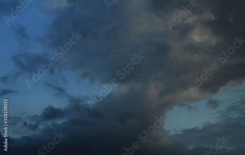 Picturesque clouds in the sky. Window view of an airplane on a sunny gloomy day. Stock photo background