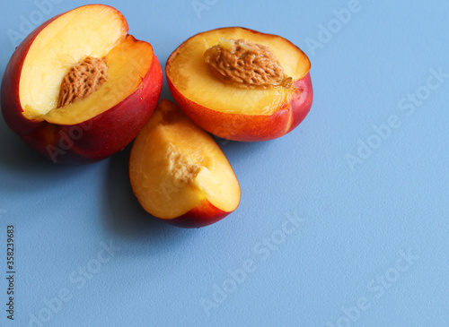 ripe nectarines on a blue background close up