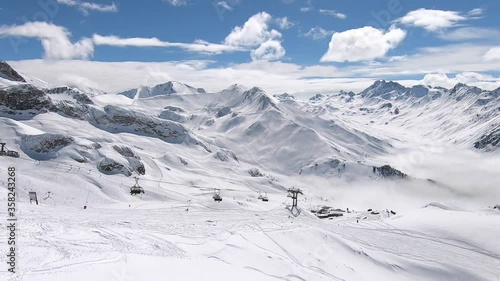 Skiresort Panorama. Endless mountain view in tyrol. Ski lift above the clouds. photo