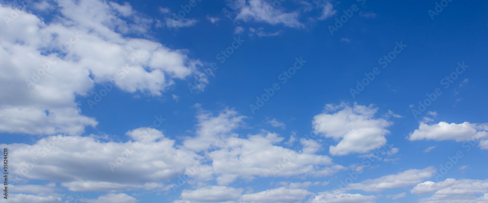 Beautiful blue skies with white fluffy clouds in the daytime. Panoramic view.