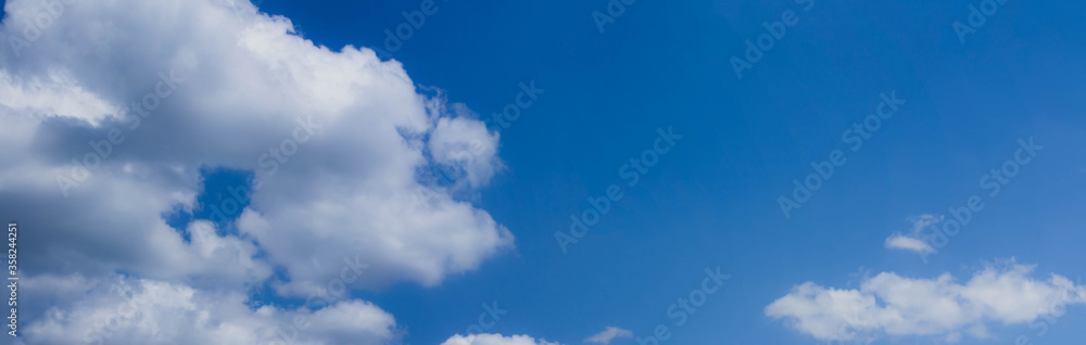 Beautiful blue skies with white fluffy clouds in the daytime. Panoramic view. Beautiful blue skies with white fluffy clouds in the daytime. Panoramic view.