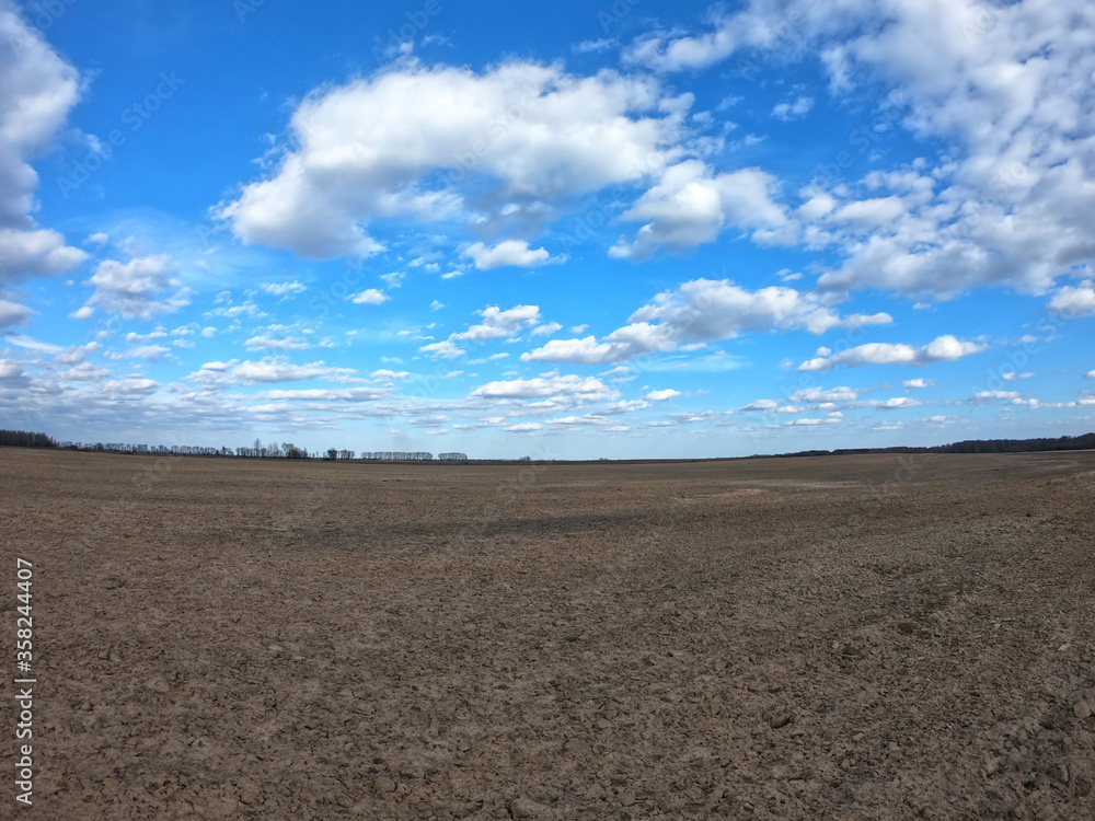 Clear blue sky over a plowed field. Landscape. Clear blue sky over a plowed field. Landscape.