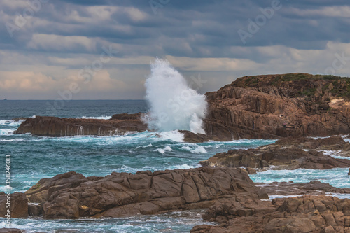 Rocky Seascape with Blue Aquamarine Sea and Earthy Brown Rocks