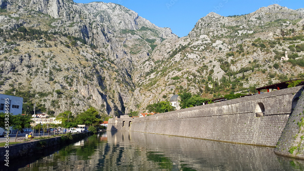 Obraz premium old wall of old town Kotor in Montenegro and light gray mountains