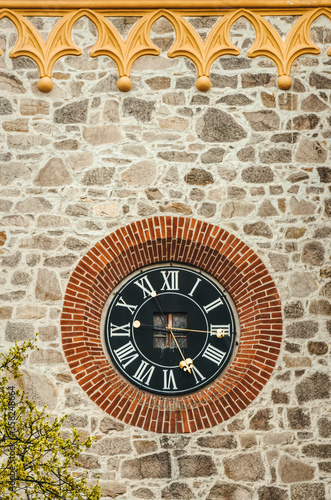 Old clock on the wall, Gothic clock tower in the square of the medieval city