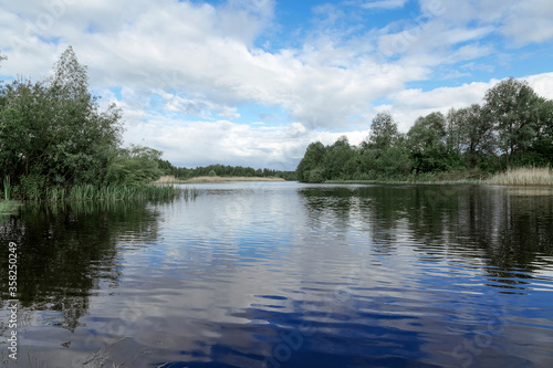 wide river landscape against the blue sky and forest