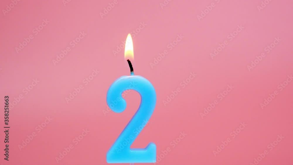 Light a candle number 2 on pink background.
Light a candle number 2 on pink background.