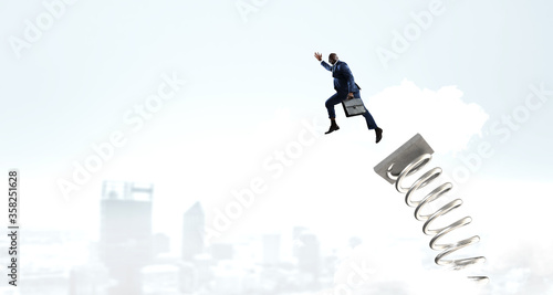 Wallpaper Mural Businessman jumping on springboard . Mixed media Torontodigital.ca