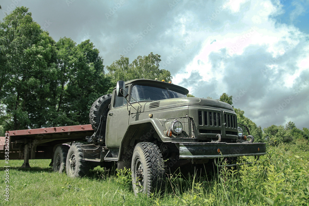 Old truck in very poor condition. A car stands in nature like abandoned metal rubbish. Stock photo background for design.