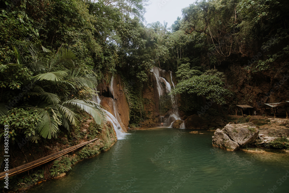 Naklejka premium nature stamp with a beautiful waterfall on the island of bohol in the philippines