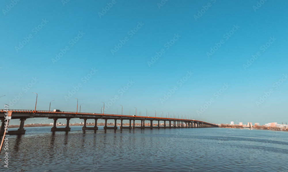 Long bridge over the river on a sunny summer day. Long bridge over the river on a sunny summer day.