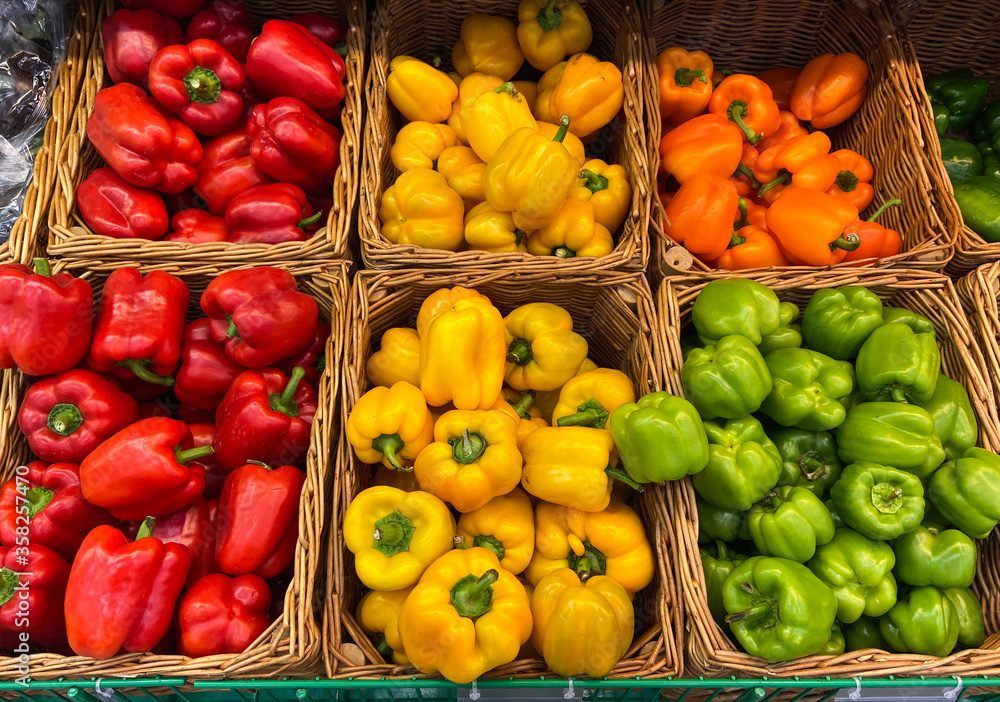 wicker basket of bell peppers on the store counter. farmers market fresh vegetables natural products wicker basket of bell peppers on the store counter. farmers market fresh vegetables natural products
