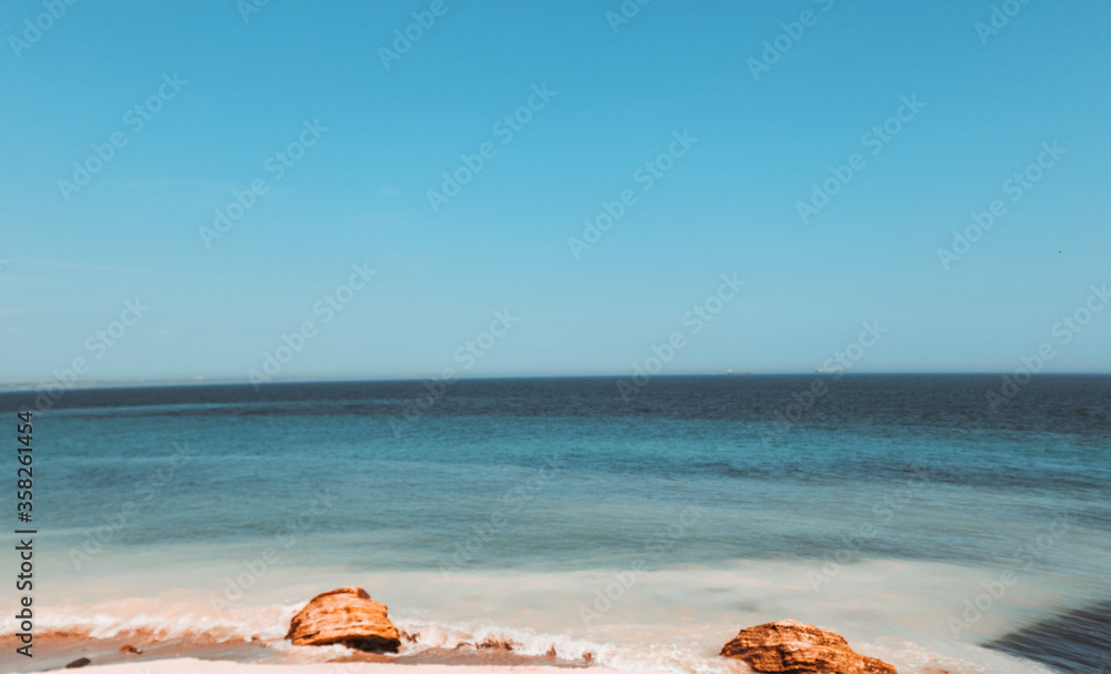 Landscape with the black sea in Odessa and stones on the beach on a hot sunny day. Landscape with the black sea in Odessa and stones on the beach on a hot sunny day.