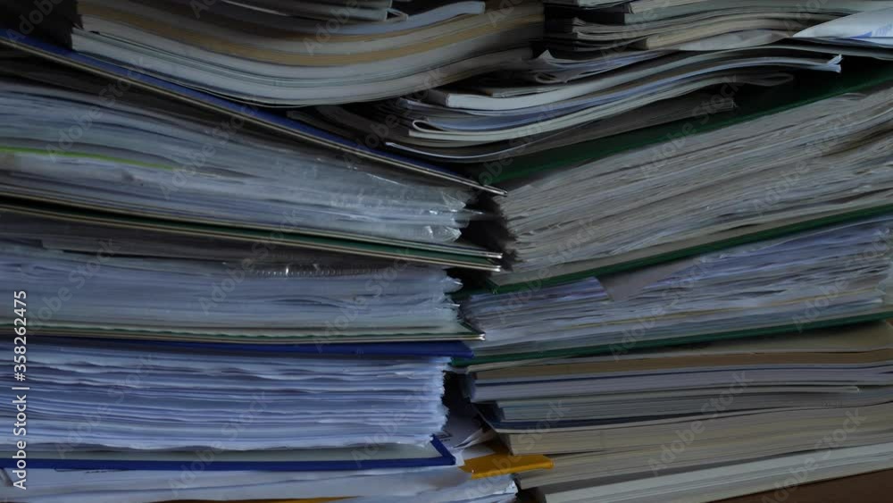 working in office with documents, binders full of documents working in office with documents, binders full of documents