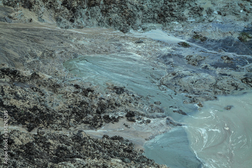 Dug hole in the ground is filled with water to the level. Swamp from the element that destroyed human activity. Stock abstract background