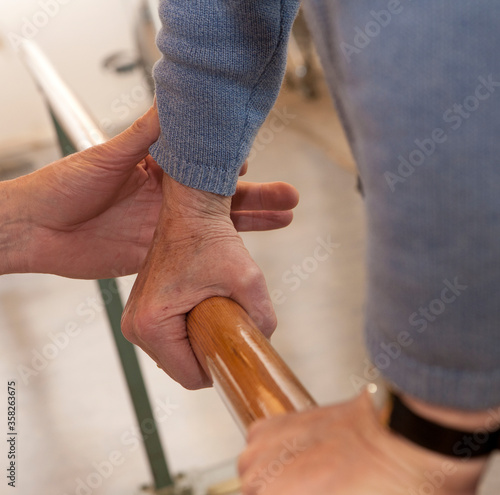 Hands. Giving support when walking. Physiotherapy for elderly. Revalidation. Handbar. Support. photo