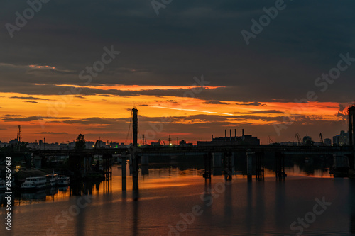 Kiev (Kyiv), Ukraine - June 15, 2020: Dnipro river and industrial area during the sunset © Bohdan