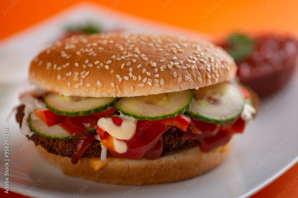 Falafel vegetarian burger with vegetables isolated on white plate