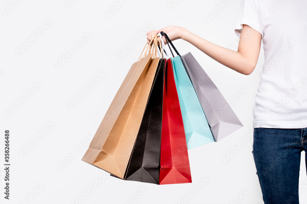Young woman holding shopping bags on white background. Isolated background