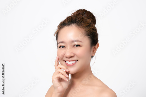 Close up of a beautiful asian woman's face. She touches her face.