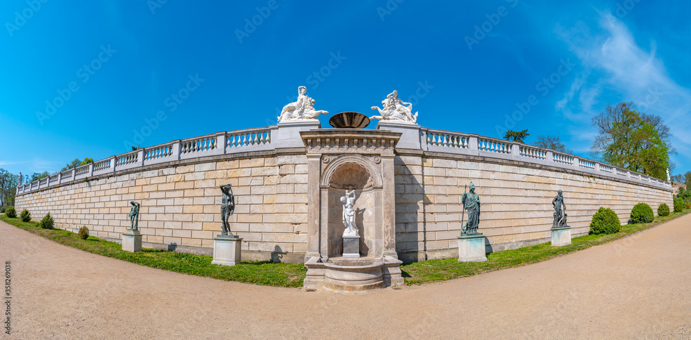 Panoramic view of an old wall as fence with many ancient statues Roman Renaissance Era in the city park of Potsdam, a German town of statues and sculptures, Germany