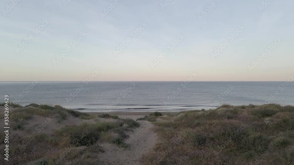 Aerial reveal shot of empty sand beach and calm ocean in Las Mimosas Marbella Aerial reveal shot of empty sand beach and calm ocean in Las Mimosas Marbella