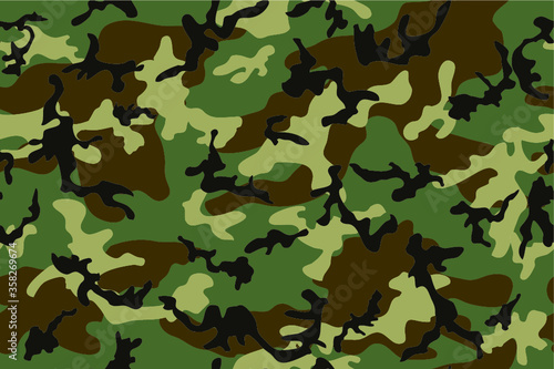 Camouflage seamless pattern. Woodland style. Green background. Four colors 