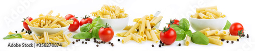 Four formats of artisanal durum wheat pasta: casarecce, tortiglioni, penne rigate and sedani rigati isolated on a white background with cherry tomatoes, basil and peppercorns.