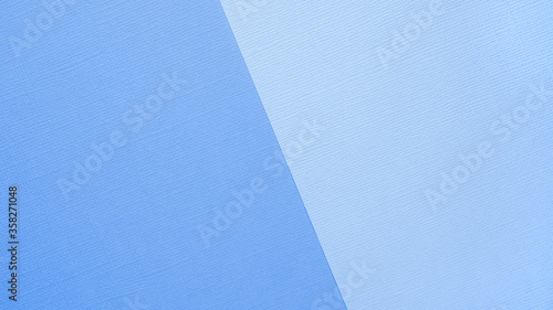 Textural background in trendy pastels: light blue and azure in a minimalistic concept. Flat bed, top view