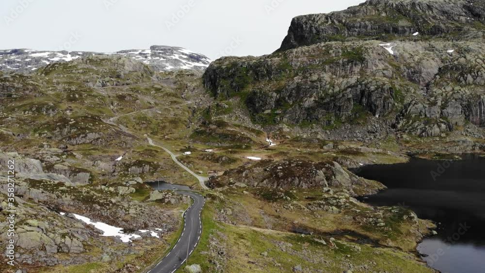 Aerial view. Norway landscape. Road and lakes in stony rocks mountains. Norwegian national tourist scenic route Ryfylke.
Aerial view. Norway landscape. Road and lakes in stony rocks mountains. Norwegian national tourist scenic route Ryfylke.
